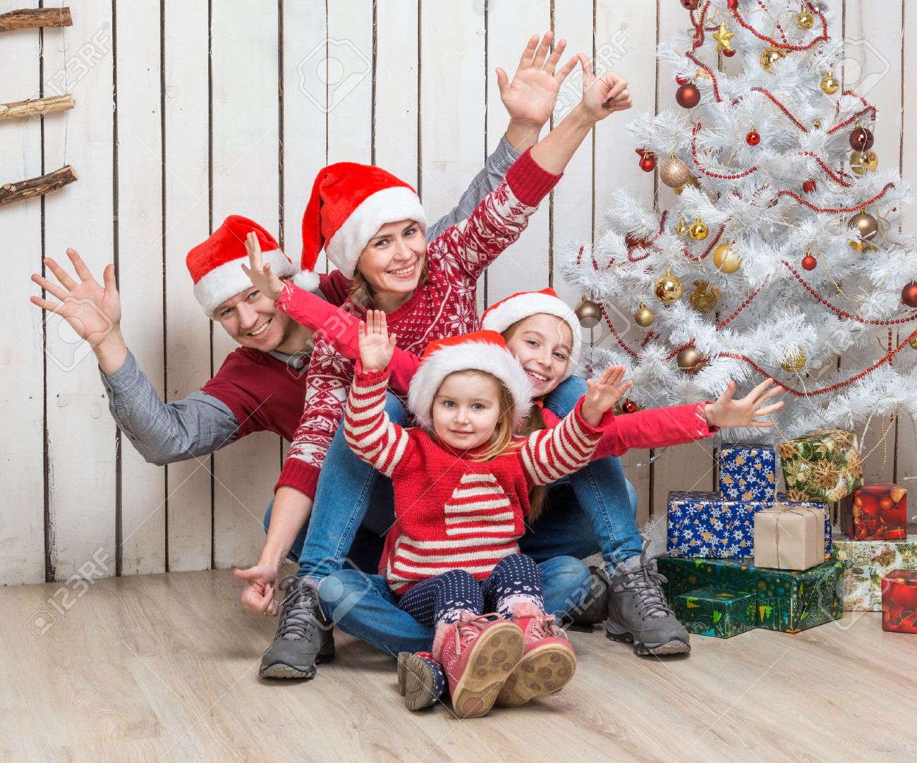 big family in red santa hats near the faux christmas tree in studio - 50031763 big family in red santa hats near the faux christmas tree in studio - 50031763