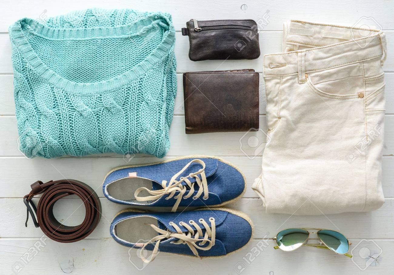 carefully folded woman casual closes and accessories on wooden table top view - 64184765 carefully folded woman casual closes and accessories on wooden table top view - 64184765