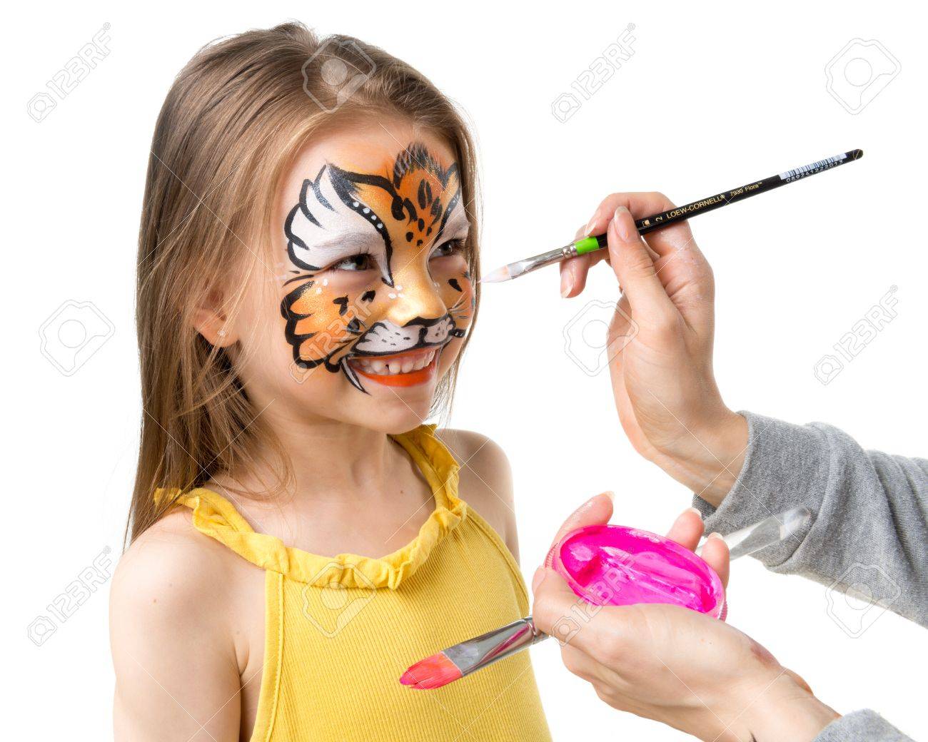 joyful little girl getting her face painted like tiger by artist - 66160250 joyful little girl getting her face painted like tiger by artist - 66160250
