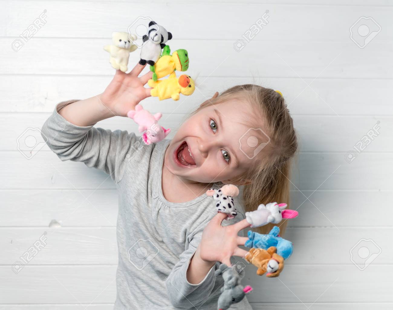 girl with doll puppets on her hands - 76604277 girl with doll puppets on her hands - 76604277