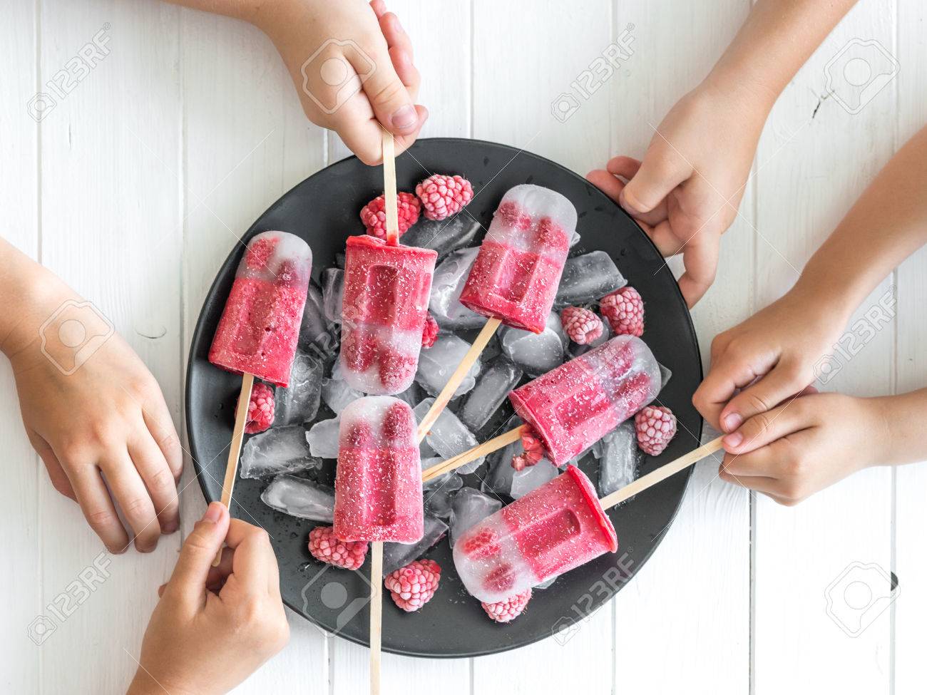 Childrens hands take the ice cream - 81852534 Childrens hands take the ice cream - 81852534