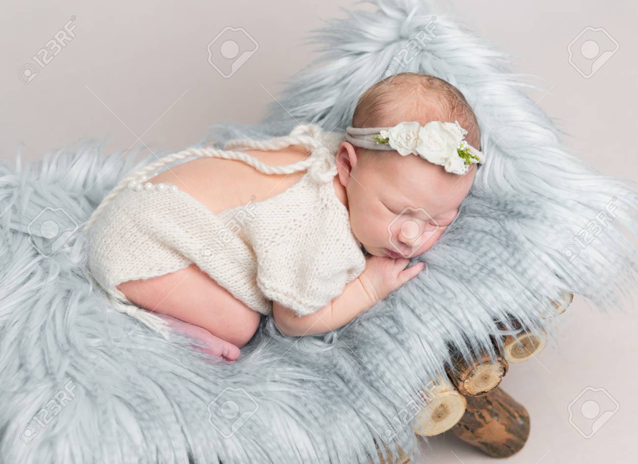 Newborn baby girl sleeps on small wooden crib. - 91187388 Newborn baby girl sleeps on small wooden crib. - 91187388