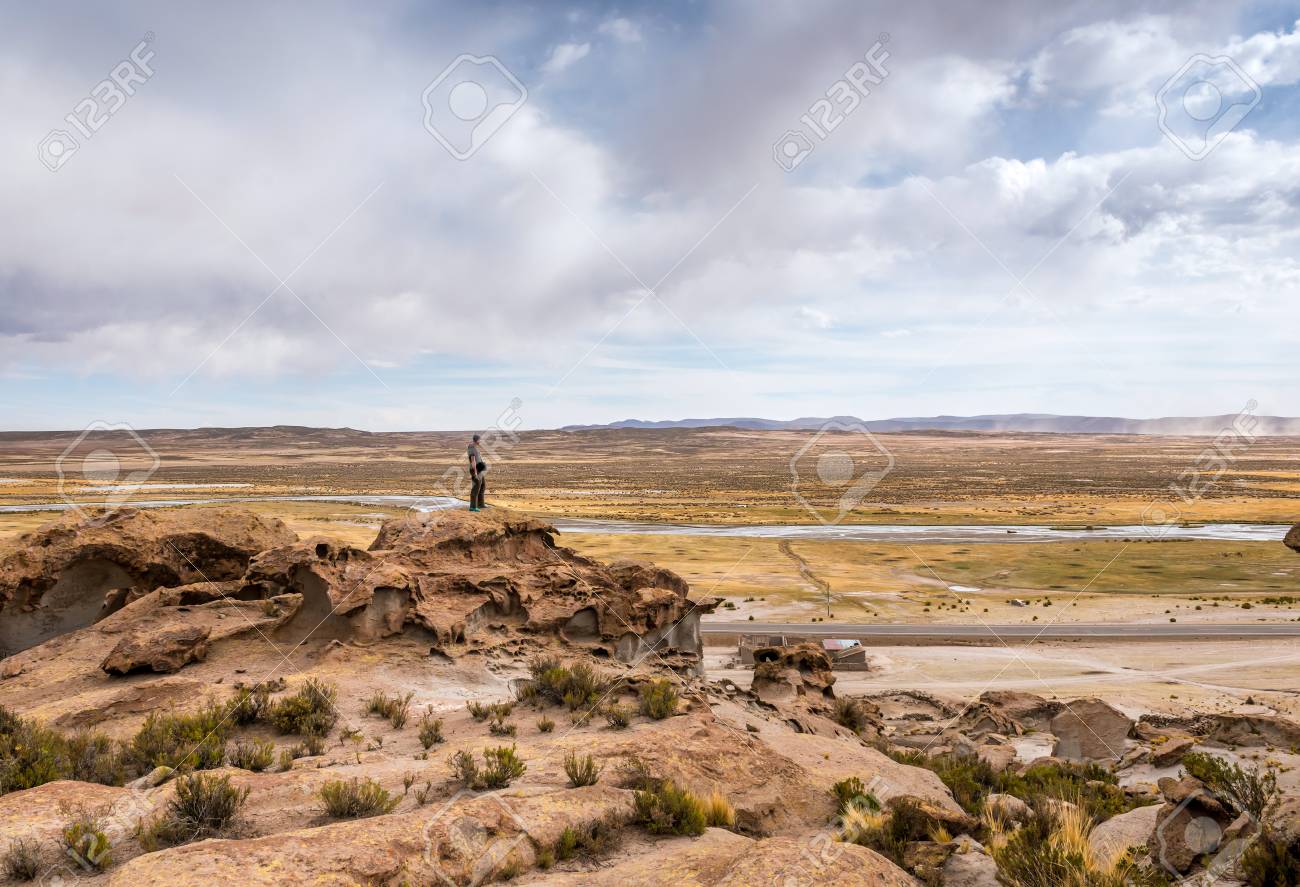 Man standing on the edge of rocky hill in Bolivia - 112880337 Man standing on the edge of rocky hill in Bolivia - 112880337