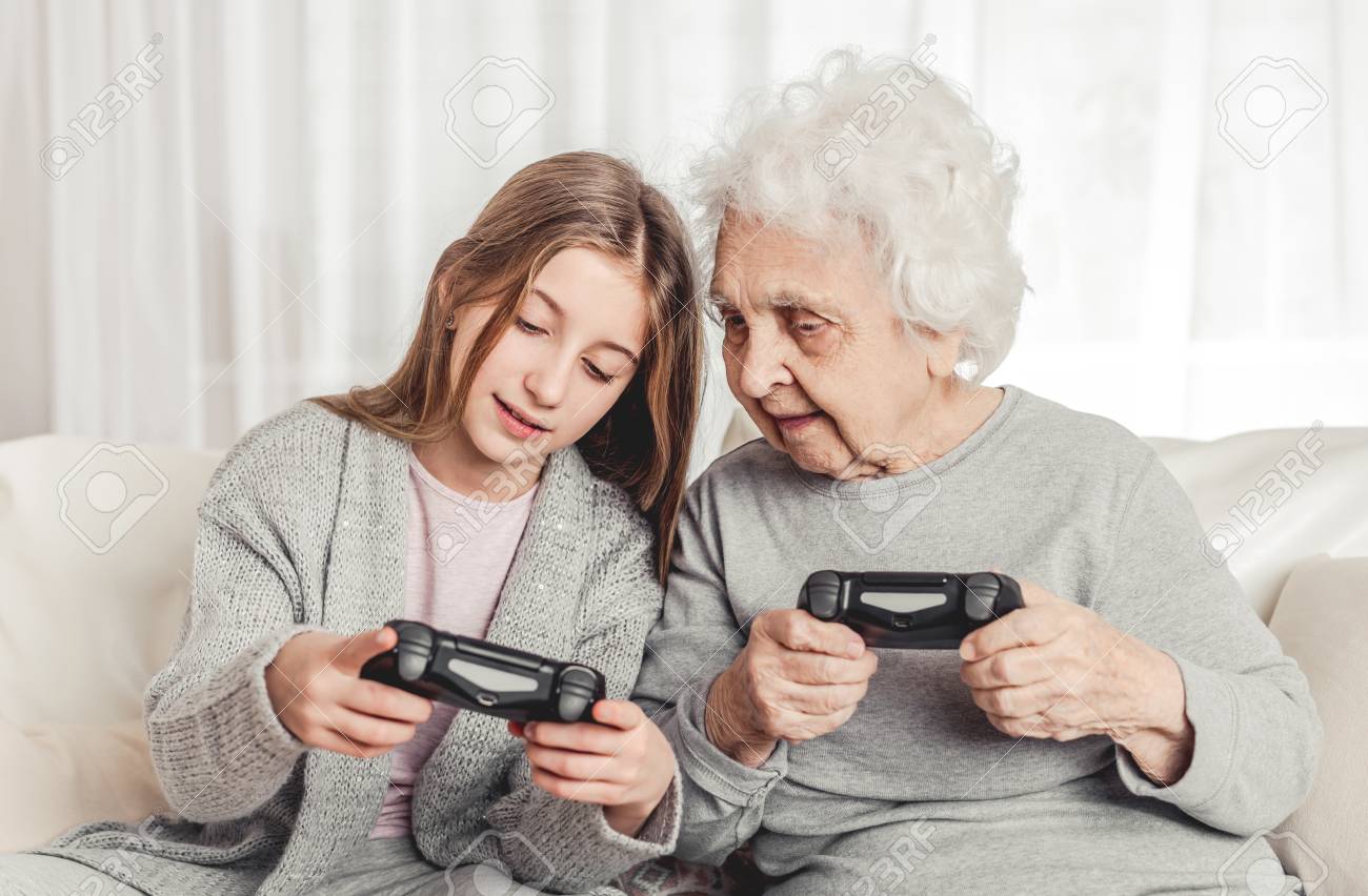 Grandmother with granddaughter playing games - 115999709 Grandmother with granddaughter playing games - 115999709