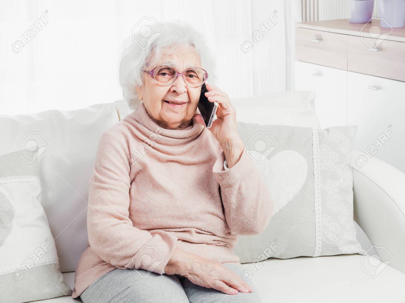 Great-grandmother talking by smartphone - 118405623 Great-grandmother talking by smartphone - 118405623