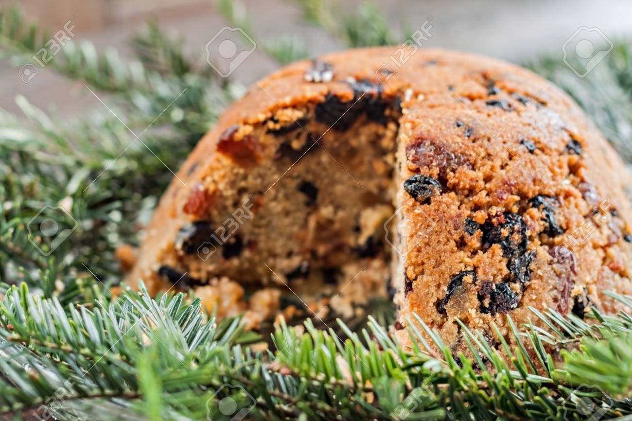 christmas plum pudding in the section on fir branches stock photo christmas plum pudding