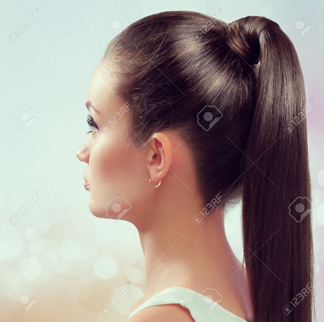 Young female with healthy shining brown hairs put in pony tail. - 24894688 Young female with healthy shining brown hairs put in pony tail. - 24894688