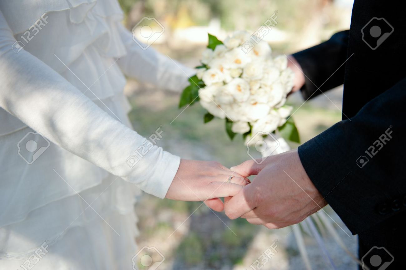 Closeup Of A Wedding Couple Holding Hands Wearing A Wedding Ring Stock Photo Picture And Royalty Free Image Image