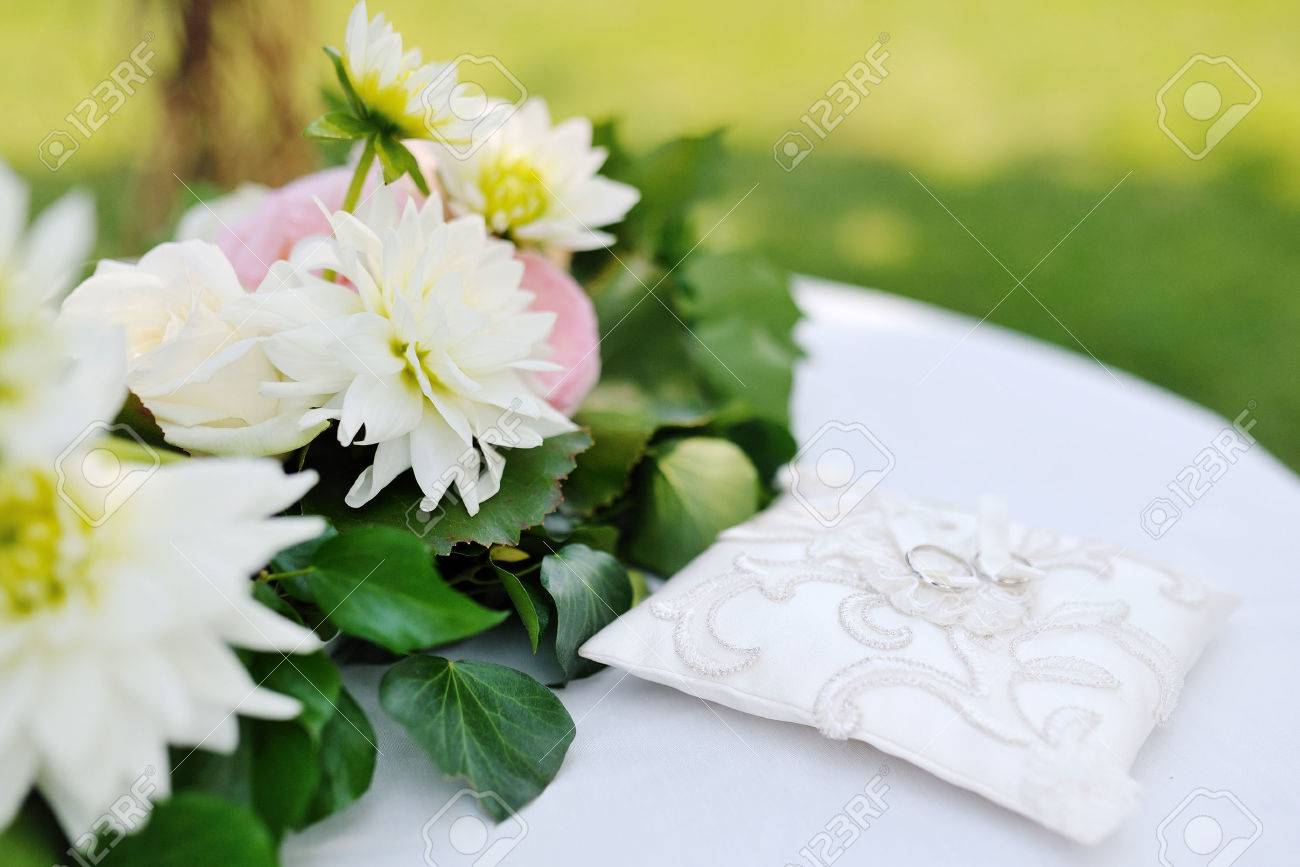 wedding rings on a little white pillow near flowers - 25122861 wedding rings on a little white pillow near flowers - 25122861