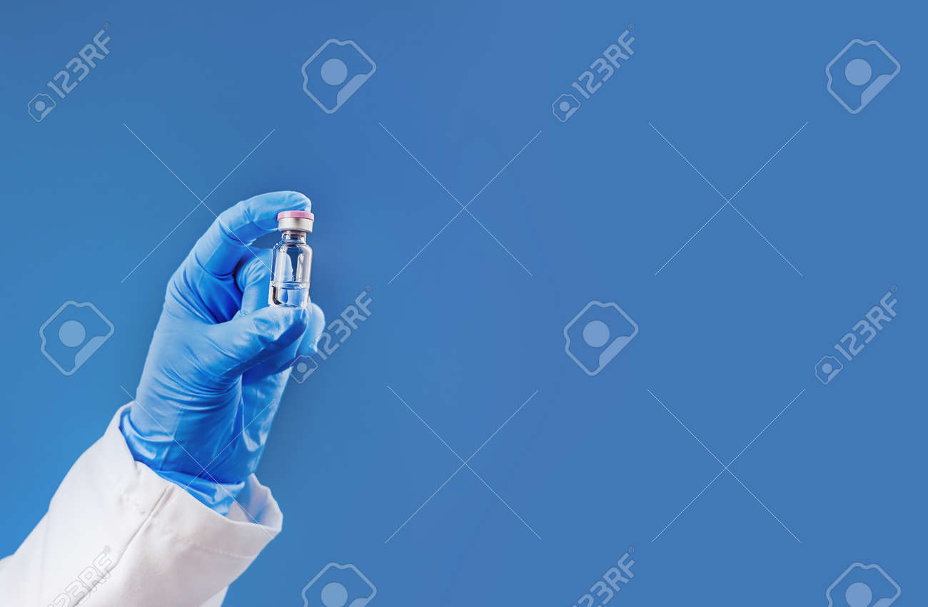 Medicine or vaccine vial in a hand of doctor or nurse and medicine or vaccine vial. Vaccination and immunization concept. Medicine and health care. Vaccine trials and research. Pharmacy. Copy space - 149881729 Medicine or vaccine vial in a hand of doctor or nurse and medicine or vaccine vial. Vaccination and immunization concept. Medicine and health care. Vaccine trials and research. Pharmacy. Copy space - 149881729