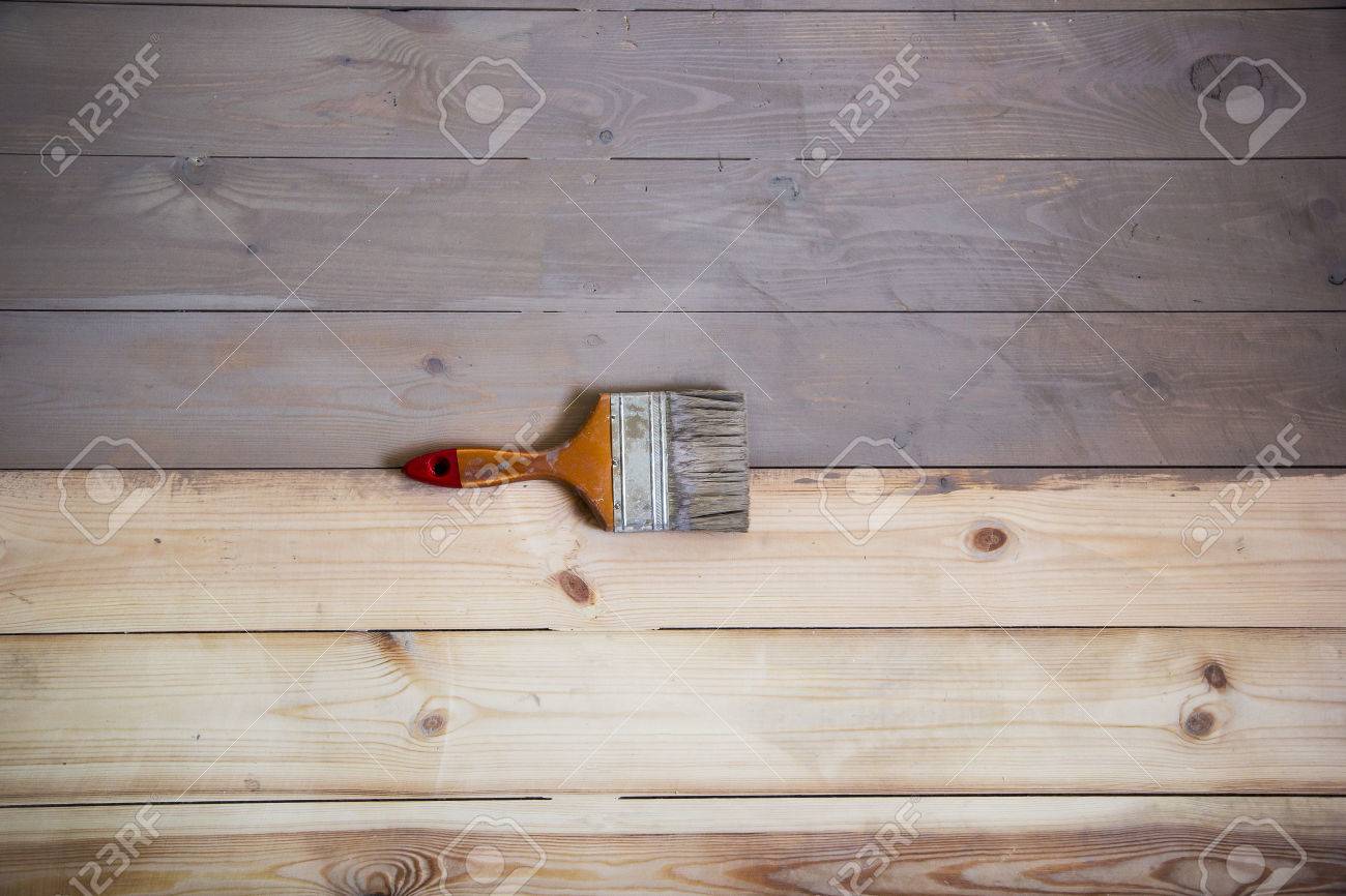 Painted Wooden Floor With Grey Colour And A Brush On The Floor