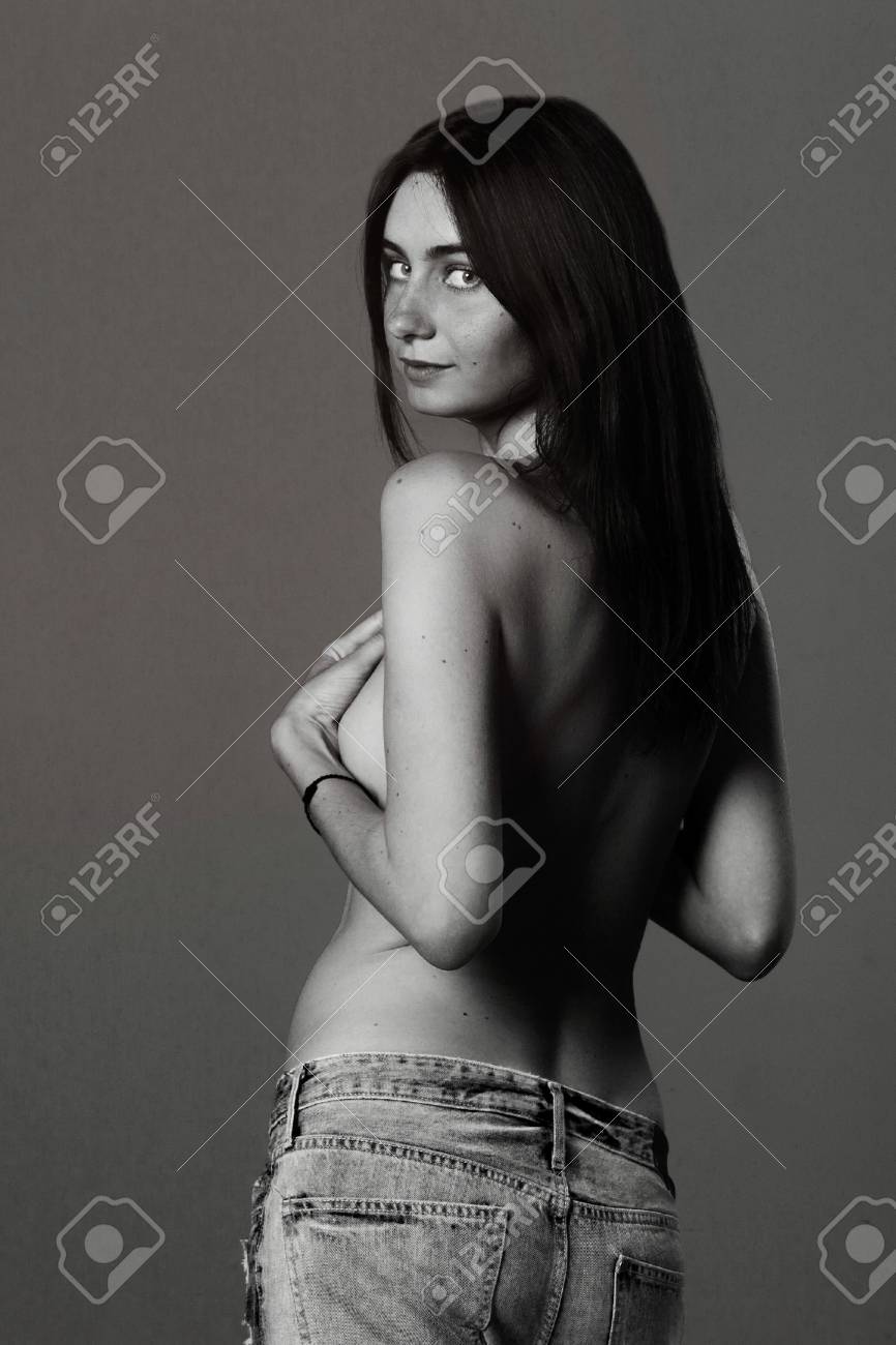 Young Woman Casual Studio Portrait In Jeans And Nude Back, Smiling And  Looking At The Camera Stock Photo, Picture and Royalty Free Image. Image  83498463.