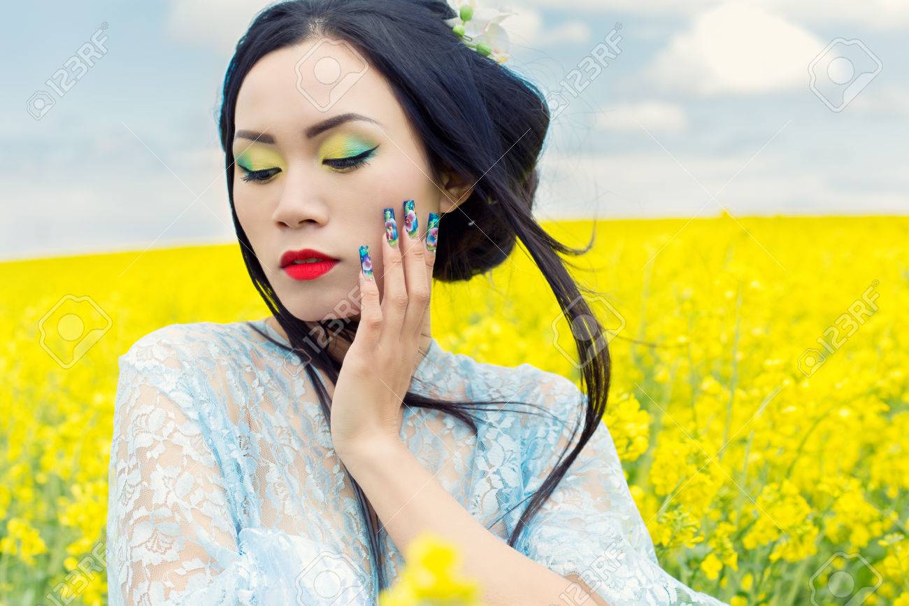 Beautiful Chinese Girl In Kimono With Long False Nails With Red Lipstick In Rape Stock Photo Beautiful Chinese Girl In Kimono With Long False Nails With Red Lipstick In Rape Stock Photo