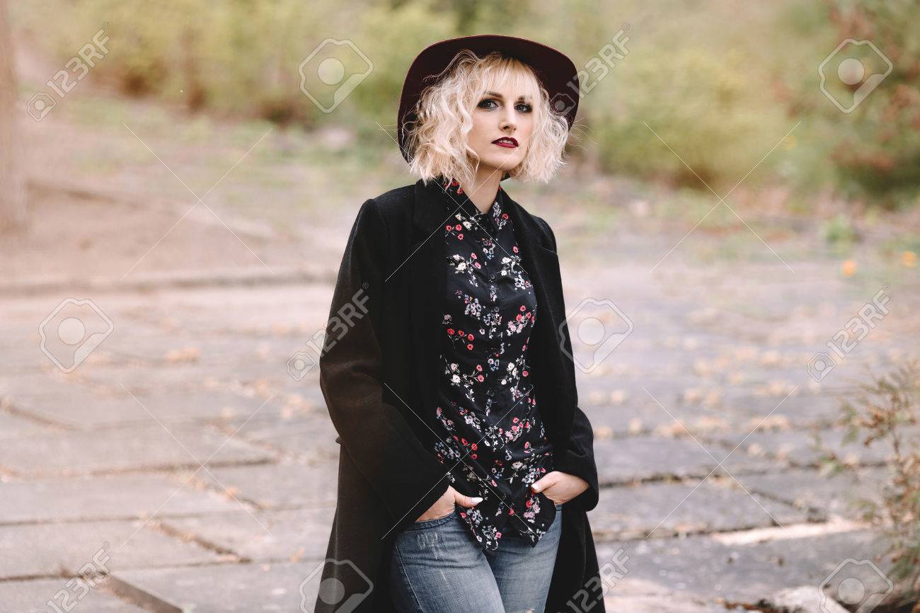 Beautiful Cheerful Blonde Girl With Short Curly Hair In Coat