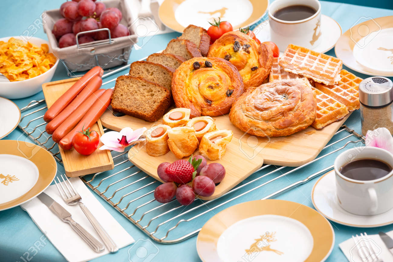 Breakfast Served in the morning with cereal bread, raisin bread, banana bread, sausage bread, chicken sausage, Natural corn flake breakfast cereal in cups and fruit on the breakfast table every day - 157501513 Breakfast Served in the morning with cereal bread, raisin bread, banana bread, sausage bread, chicken sausage, Natural corn flake breakfast cereal in cups and fruit on the breakfast table every day - 157501513