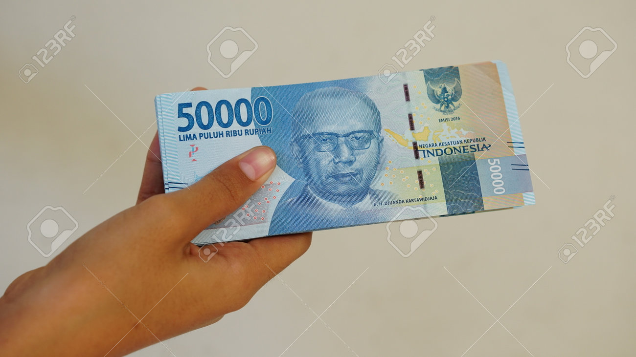 Indonesian Rupiah Banknote, 50,000 Rupiah, Held By Woman Stock Photo,  Picture and Royalty Free Image. Image 172585737.