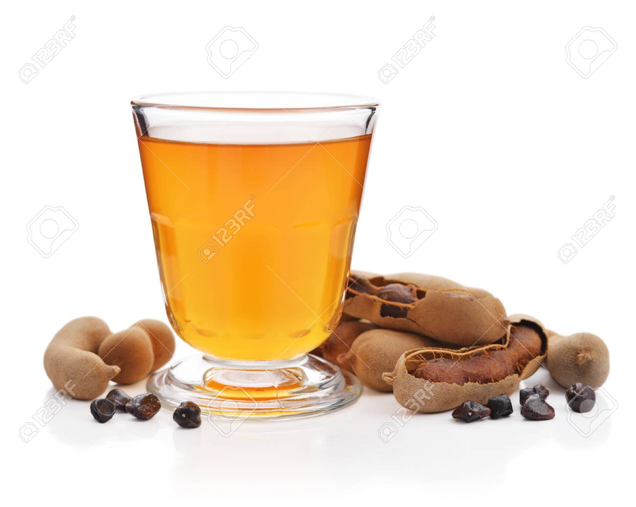 Tamarind Juice With Tamarind Pods Isolated On White Background Stock Photo Picture And Royalty Free Image Image