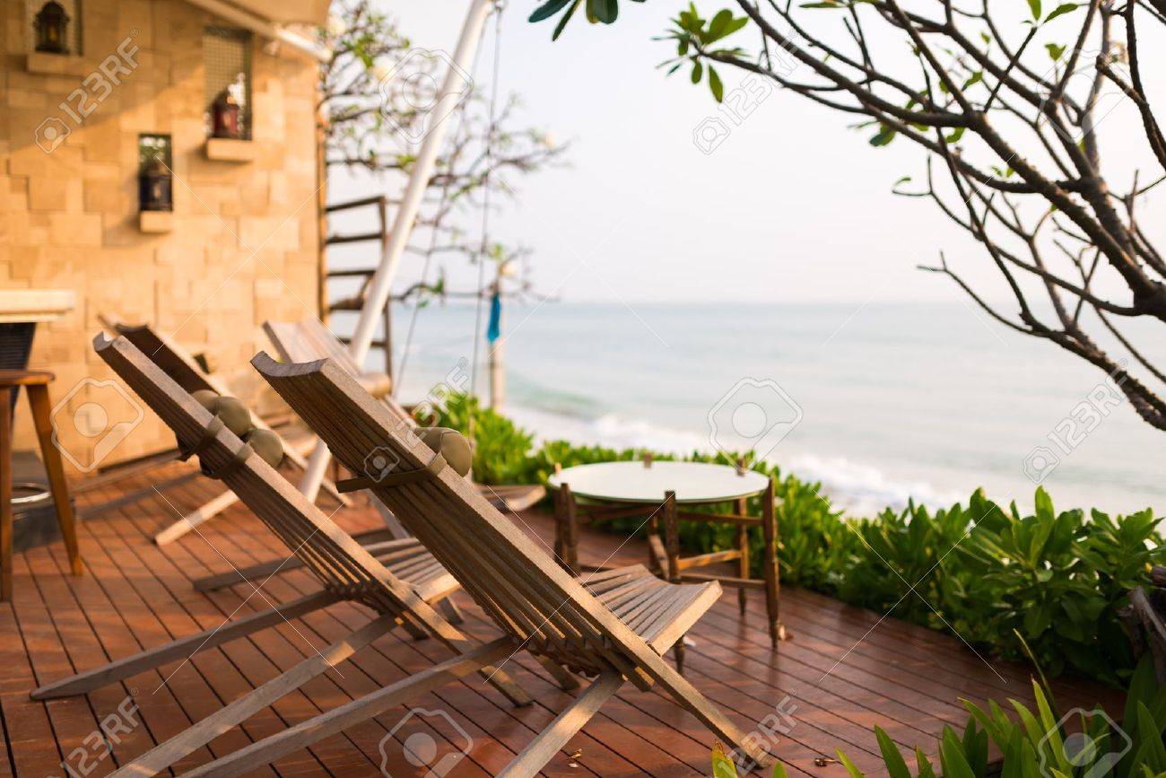Wooden chairs on balcony of hotel by the beach - 22176992 Wooden chairs on balcony of hotel by the beach - 22176992