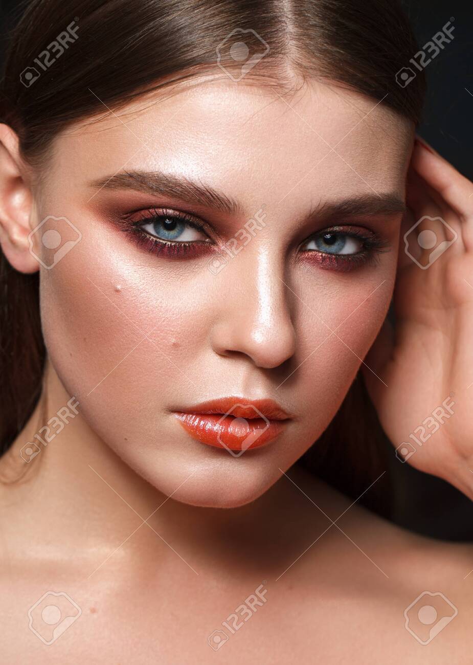 Perfect model with the professional colorful makeup, perfect skin and red smoky eyes. Closeup portrait. - 133209077 Perfect model with the professional colorful makeup, perfect skin and red smoky eyes. Closeup portrait. - 133209077
