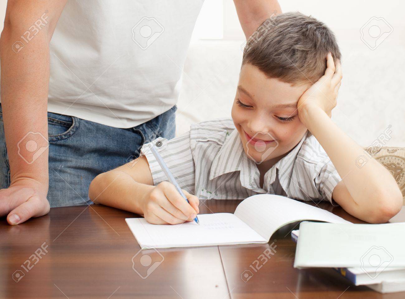 father helping son do homework parent helps his child stock photo parent helps