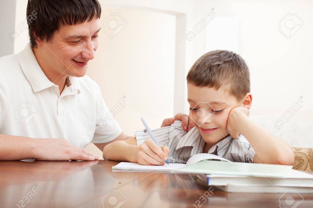 father helping son do homework parent helps his child stock photo parent helps