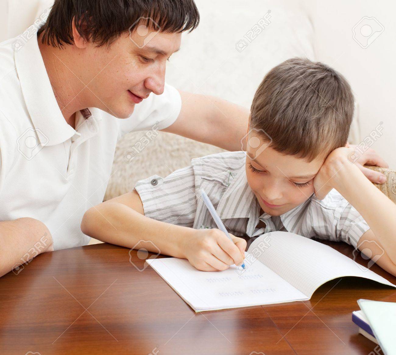 father helping son do homework parent helps his child stock photo parent helps