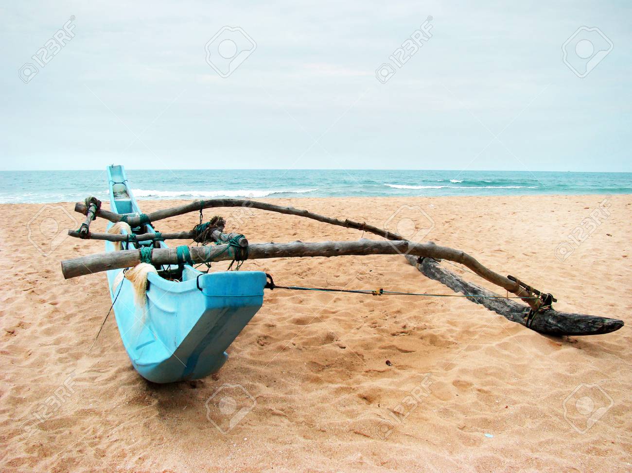 Homemade Single Outrigger Kit for Swagman Canoe on Sandy Beach Overlooking Ocean and Horizon - Summer active sports and recreation. - 101922429 Homemade Single Outrigger Kit for Swagman Canoe on Sandy Beach Overlooking Ocean and Horizon - Summer active sports and recreation. - 101922429