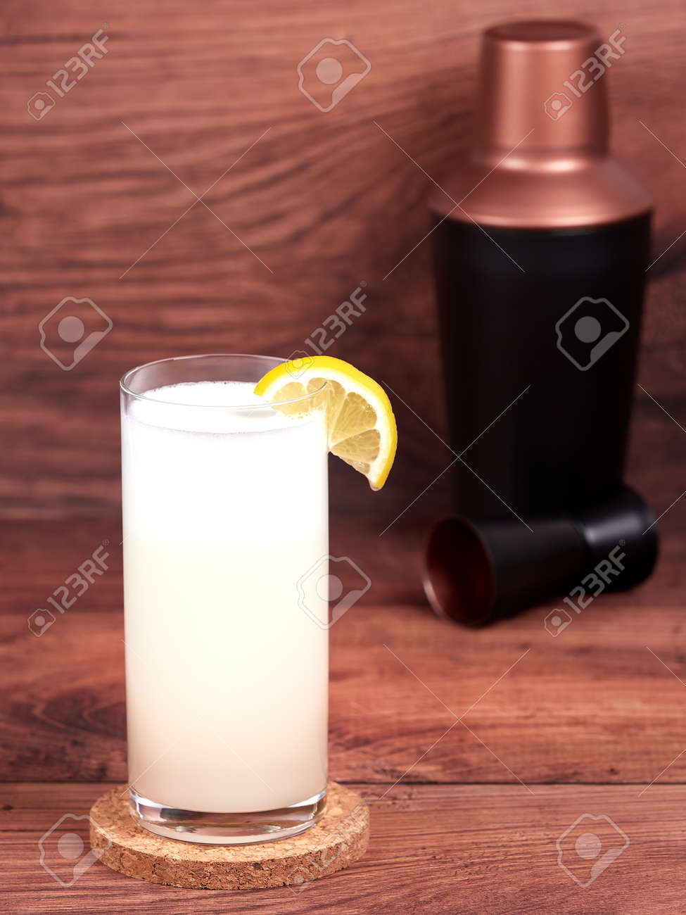 Gin fizz: a cocktail made with gin, lemon juice, simple syrup, egg white and soda water - 157025453 Gin fizz: a cocktail made with gin, lemon juice, simple syrup, egg white and soda water - 157025453