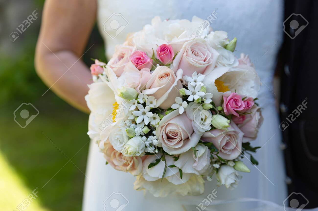 Bride Holding Blooming Flowers in Detail - 155977149 Bride Holding Blooming Flowers in Detail - 155977149