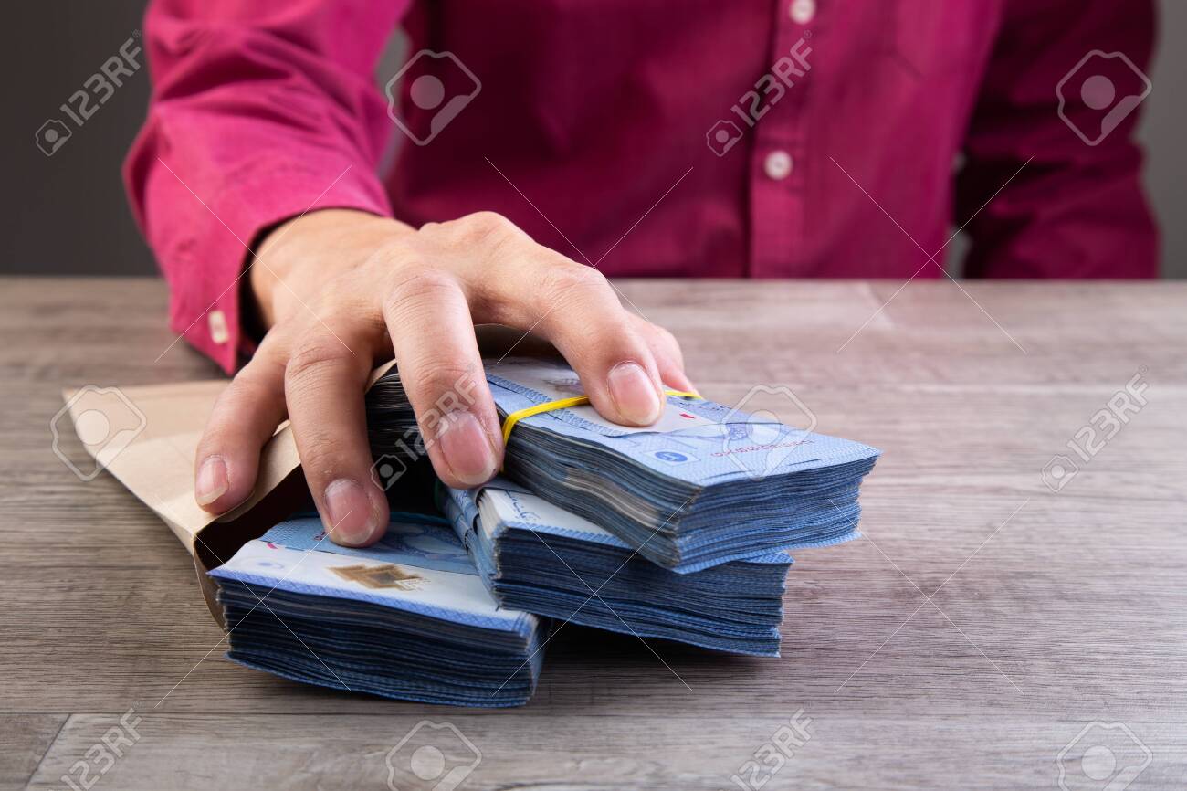 Businessman receive money in the envelope offered in file - anti bribery and corruption concepts - 150855981 Businessman receive money in the envelope offered in file - anti bribery and corruption concepts - 150855981