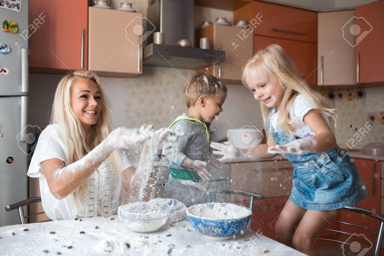 mother and children playing on kitchen with flour - 37908143 mother and children playing on kitchen with flour - 37908143