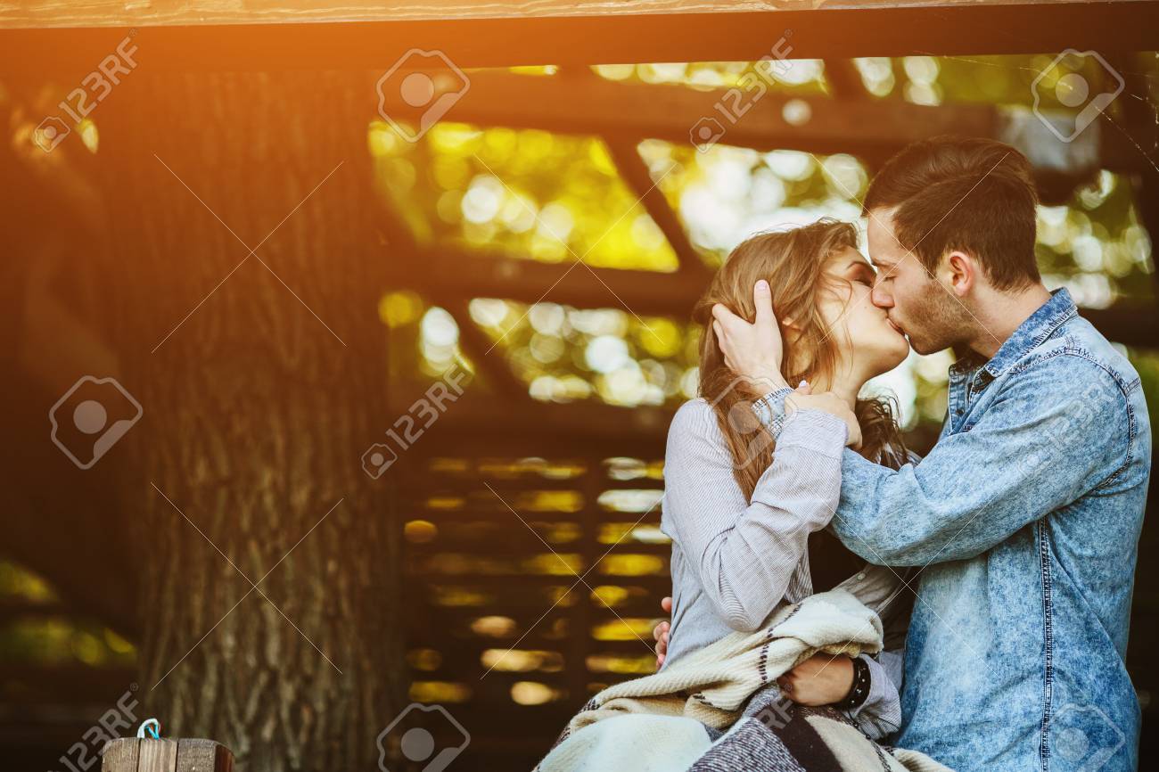 Young couple in love wrapped in plaid standing and kissing - 43523788 Young couple in love wrapped in plaid standing and kissing - 43523788