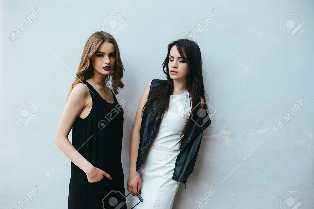 Two young and beautiful girl posing on a white background - 44418132 Two young and beautiful girl posing on a white background - 44418132