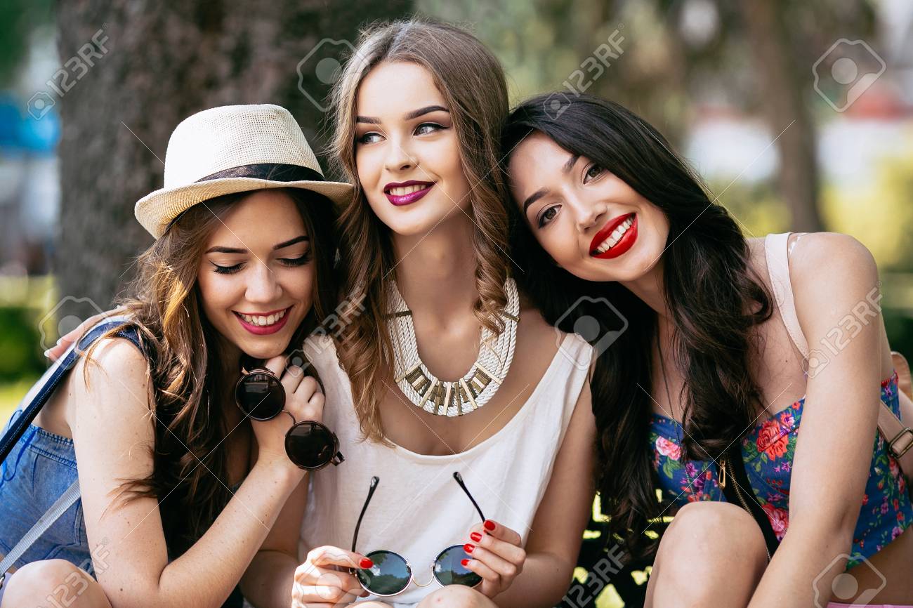 Three beautiful young girls posing against the backdrop of the park - 44421574 Three beautiful young girls posing against the backdrop of the park - 44421574
