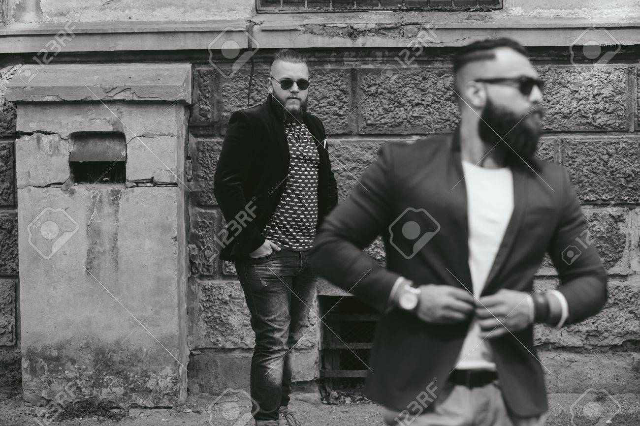 two businessmen talking on the phone in the city - 44509906 two businessmen talking on the phone in the city - 44509906