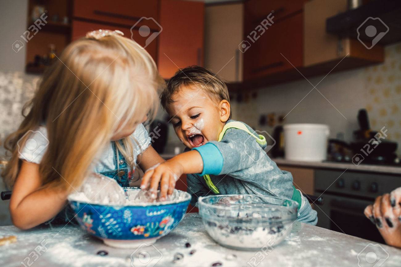 Kids is playing with flour in the kitchen - 45964897 Kids is playing with flour in the kitchen - 45964897