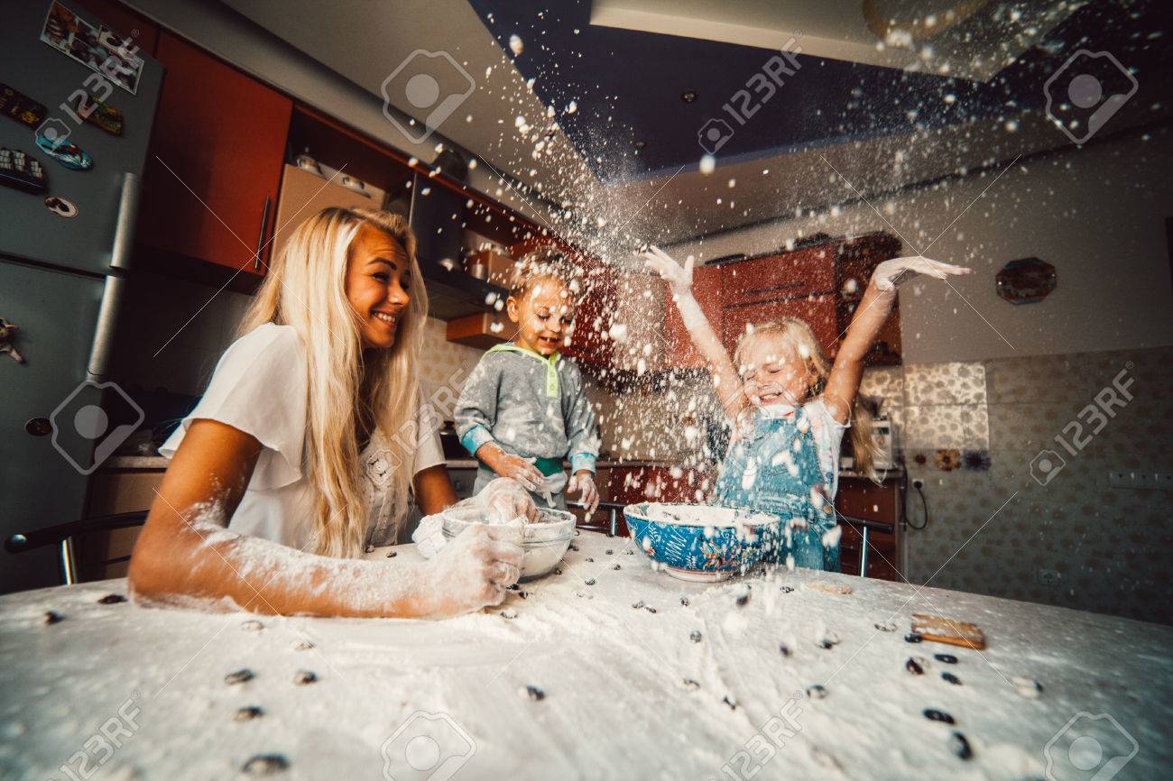 mother and children playing on kitchen with flour - 46509325 mother and children playing on kitchen with flour - 46509325