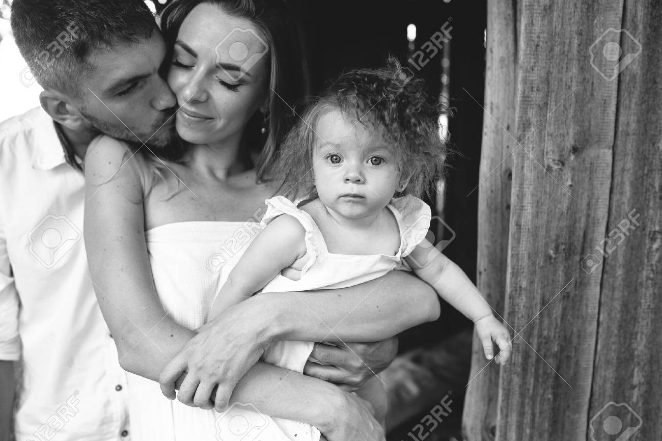 mother, father and daughter together having fun on the farm - 48556431 mother, father and daughter together having fun on the farm - 48556431