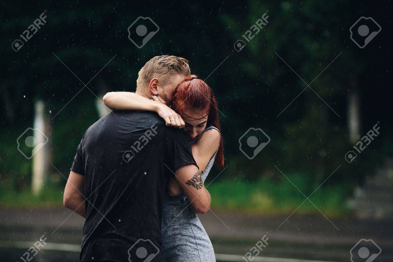 beautiful couple hugging on outside in the rain - 49612042 beautiful couple hugging on outside in the rain - 49612042
