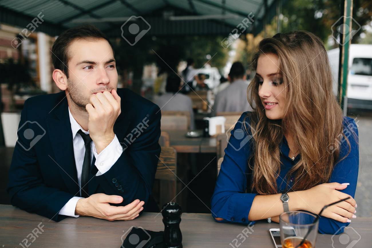 beautiful couple sitting in the cafe and having fun - 52237572 beautiful couple sitting in the cafe and having fun - 52237572