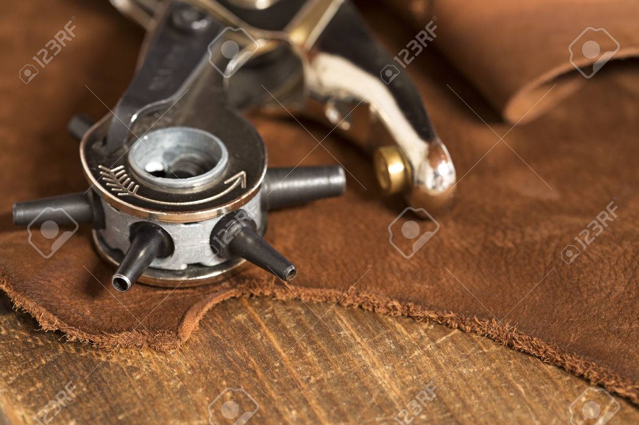 Leather craft punch on a piece of leather - 47251542 Leather craft punch on a piece of leather - 47251542