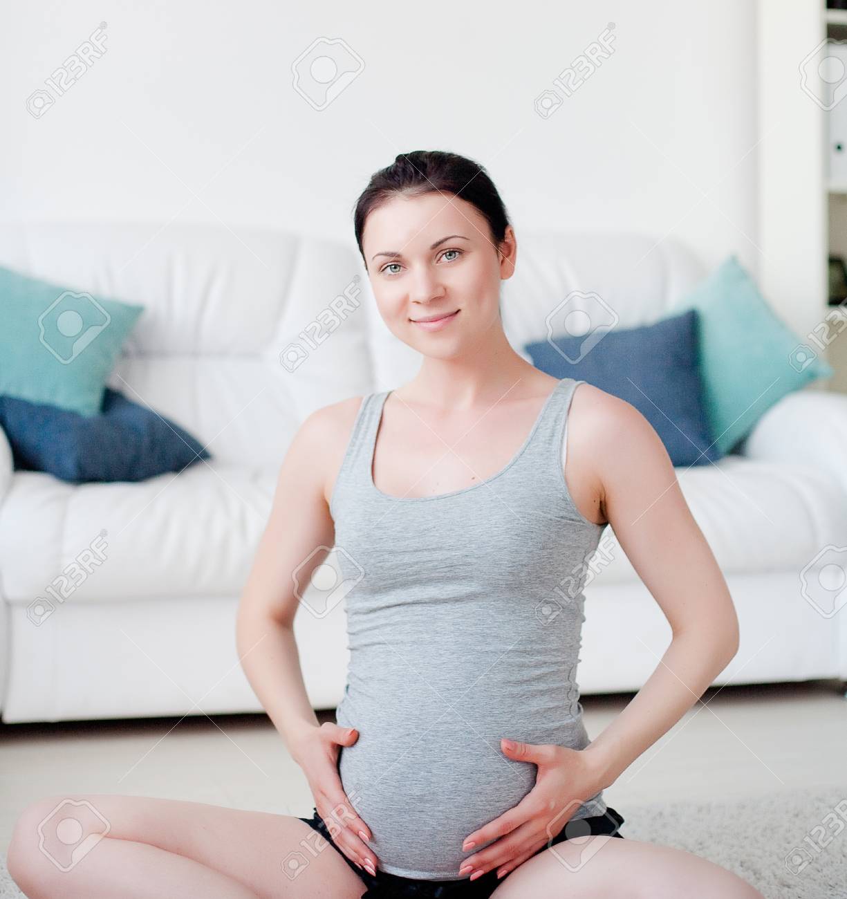 Young pregnant woman do yoga indoors - 21612124 Young pregnant woman do yoga indoors - 21612124