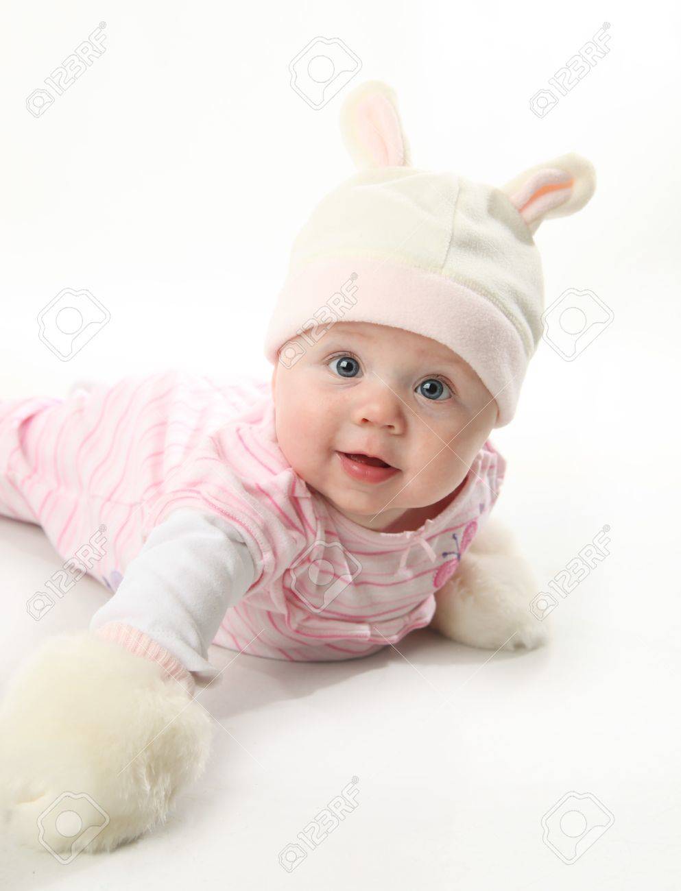 Portrait of an adorable baby girl wearing a bunny rabbit costume and furry mittens - 8710180 Portrait of an adorable baby girl wearing a bunny rabbit costume and furry mittens - 8710180
