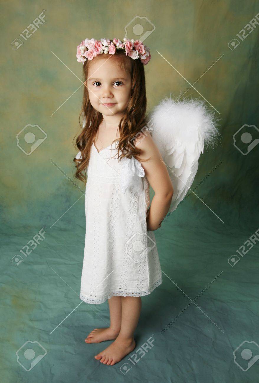 Beautiful young girl wearing angel wings and flower halo with smile happy expression - 8710183 Beautiful young girl wearing angel wings and flower halo with smile happy expression - 8710183