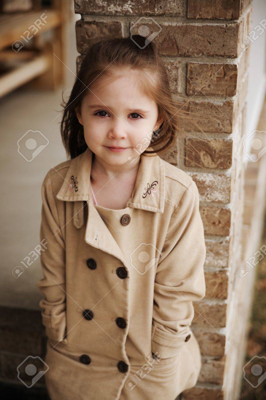 Beautiful young preschool girl outdoors wearing a peacoat blazer in the fall - 8809414 Beautiful young preschool girl outdoors wearing a peacoat blazer in the fall - 8809414