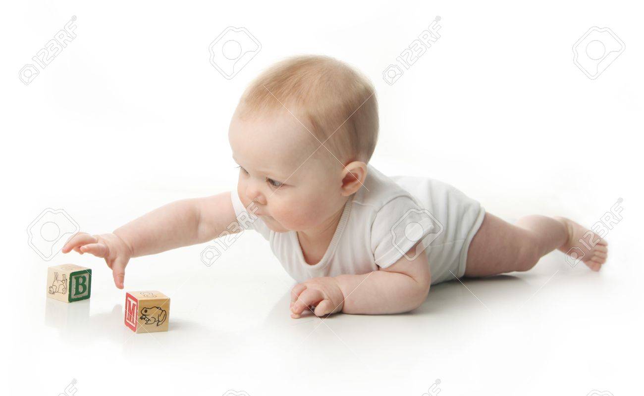 Portrait of a cute baby sitting playing with wooden blocks - 9939525 Portrait of a cute baby sitting playing with wooden blocks - 9939525