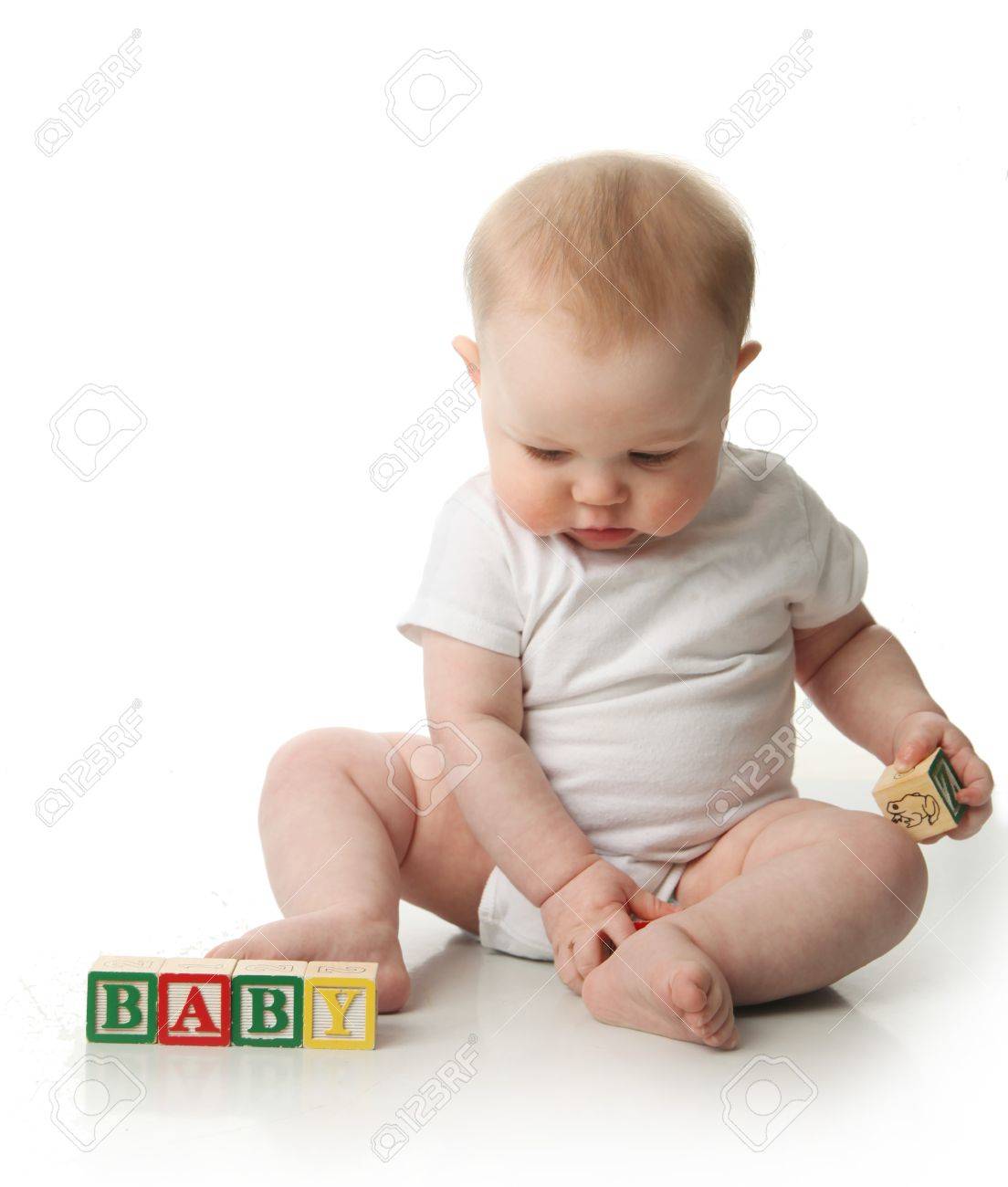 portrait of a cute baby sitting playing with wooden blocks cute baby sitting