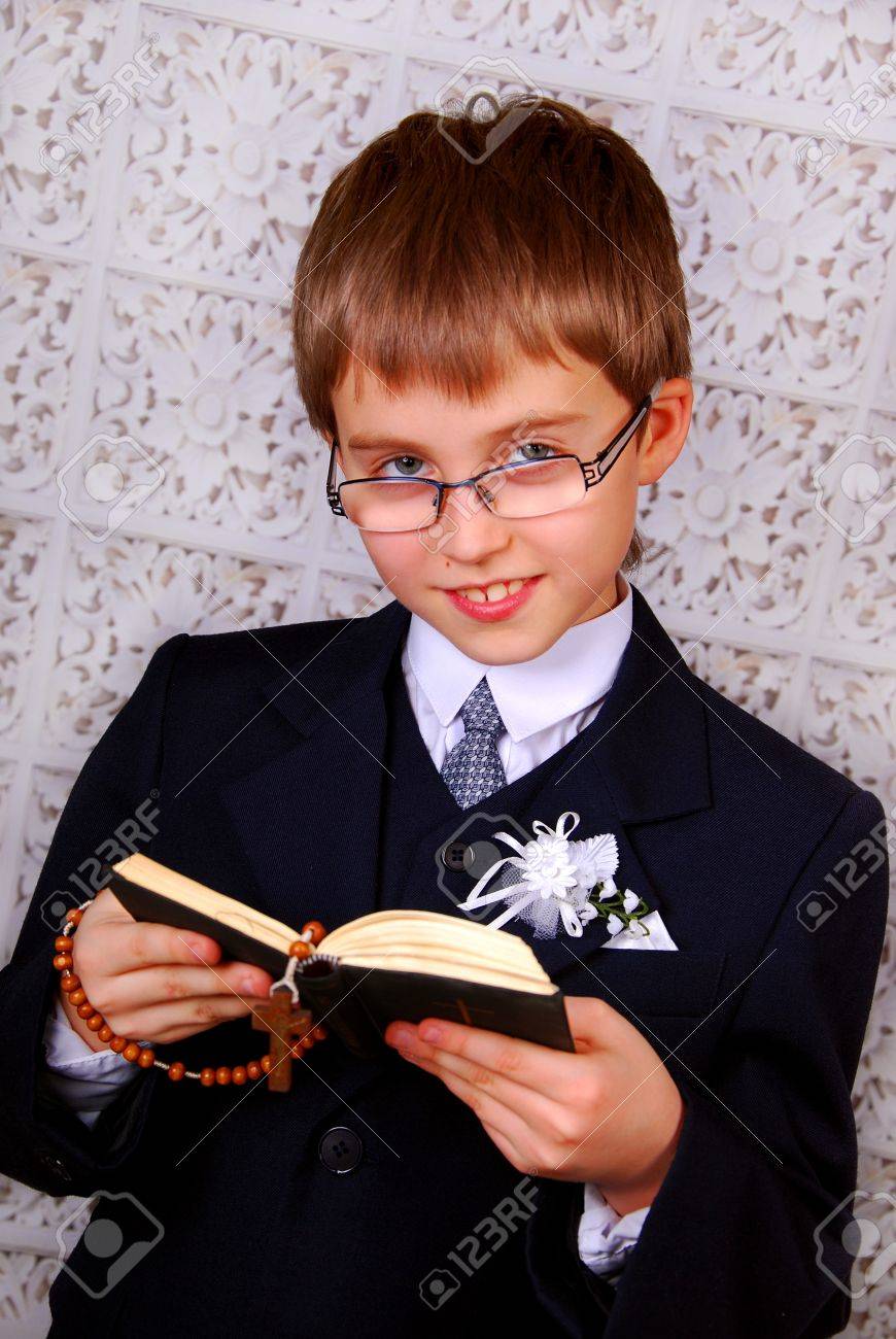 portrait of the boy going to the first holy communion with prayer book and rosary - 17816677 portrait of the boy going to the first holy communion with prayer book and rosary - 17816677
