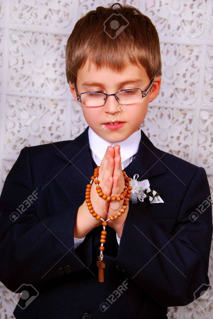 portrait of the boy going to the first holy communion praying with a rosary - 17816676 portrait of the boy going to the first holy communion praying with a rosary - 17816676