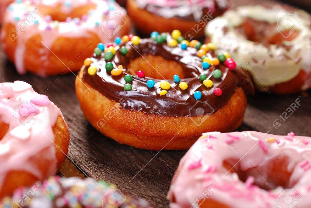 homemade colorful donuts with chocolate and icing glaze on wooden background - 40628011 homemade colorful donuts with chocolate and icing glaze on wooden background - 40628011